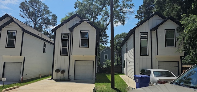 11378 Underwood St, Willis, TX 77318 - view of front of house with board and batten siding, a garage, and driveway
