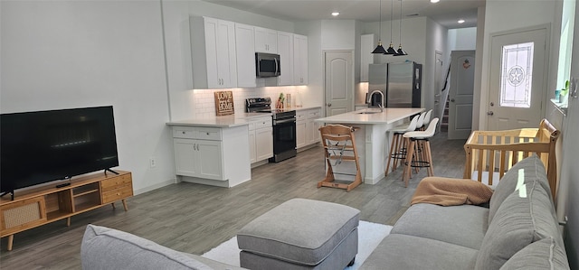 11378 Underwood St, Willis, TX 77318 - living area with light wood finished floors and recessed lighting
