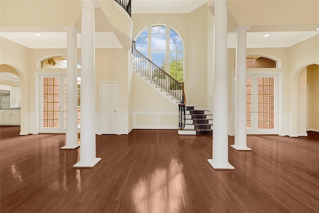16506 Emilia Ct, Spring, TX 77379 - entryway featuring crown molding, wood finished floors, ornate columns, stairway, and a high ceiling