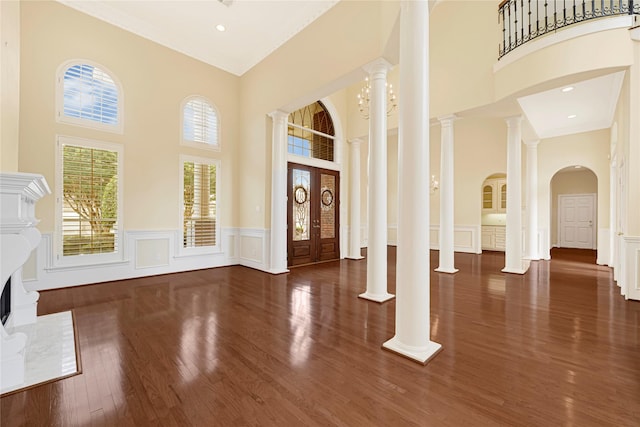 16506 Emilia Ct, Spring, TX 77379 - entryway with a towering ceiling, a decorative wall, wood finished floors, and a wainscoted wall