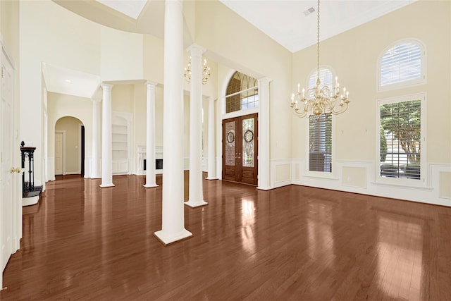 16506 Emilia Ct, Spring, TX 77379 - foyer featuring a high ceiling, wood finished floors, wainscoting, and arched walkways