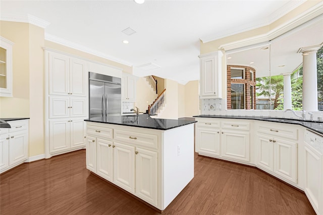 16506 Emilia Ct, Spring, TX 77379 - kitchen featuring stainless steel built in fridge, dark wood-style flooring, decorative backsplash, white cabinetry, and recessed lighting