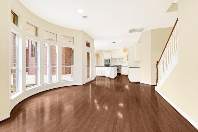 16506 Emilia Ct, Spring, TX 77379 - unfurnished living room with dark wood-style floors and stairs