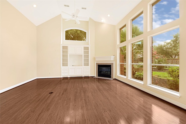 16506 Emilia Ct, Spring, TX 77379 - unfurnished living room with high vaulted ceiling, a ceiling fan, a fireplace with flush hearth, and wood finished floors