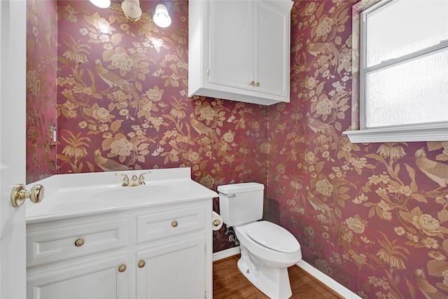 16506 Emilia Ct, Spring, TX 77379 - bathroom featuring wood finished floors, wallpapered walls, and vanity