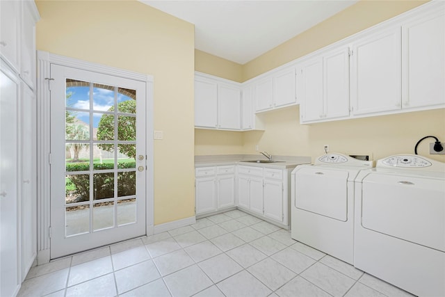 16506 Emilia Ct, Spring, TX 77379 - laundry area with cabinet space, light tile patterned flooring, and washing machine and clothes dryer