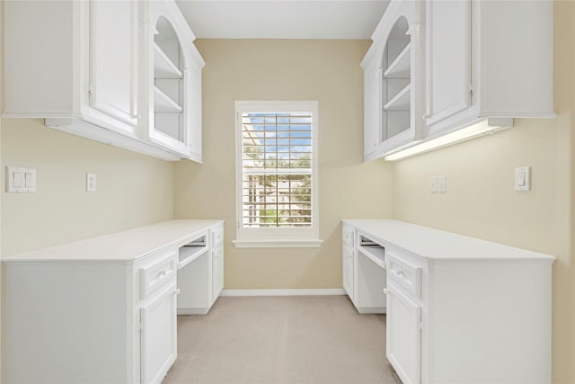 16506 Emilia Ct, Spring, TX 77379 - kitchen with open shelves, light colored carpet, light countertops, and white cabinetry