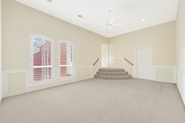 16506 Emilia Ct, Spring, TX 77379 - carpeted empty room with a decorative wall, wainscoting, a ceiling fan, stairs, and recessed lighting