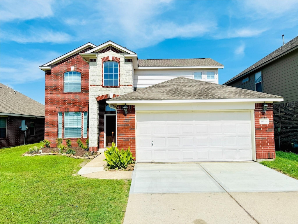 18814 Lantern Cove Ln, Tomball, TX 77375 - traditional-style house with driveway, an attached garage, a front yard, brick siding, and roof with shingles