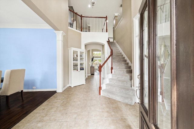 7327 Crescent Bridge Ct, Humble, TX 77396 - entryway with stairway, crown molding, arched walkways, ornate columns, and baseboards