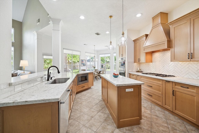 7327 Crescent Bridge Ct, Humble, TX 77396 - kitchen featuring a sink, appliances with stainless steel finishes, a kitchen island, decorative backsplash, and light stone countertops