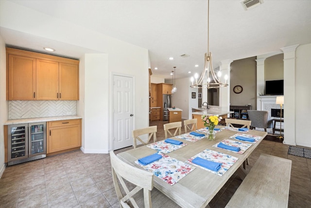 7327 Crescent Bridge Ct, Humble, TX 77396 - dining space with beverage cooler, recessed lighting, baseboards, light tile patterned floors, and a fireplace