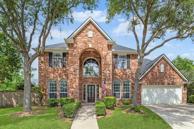 7327 Crescent Bridge Ct, Humble, TX 77396 - view of front of property with brick siding, a garage, driveway, and roof with shingles
