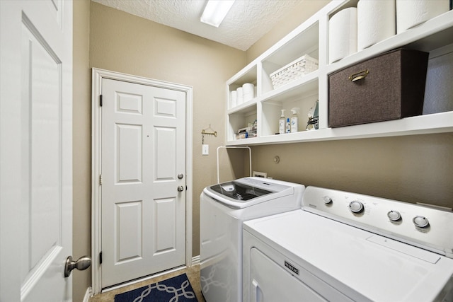 7327 Crescent Bridge Ct, Humble, TX 77396 - laundry room with washing machine and dryer, a textured ceiling, and baseboards
