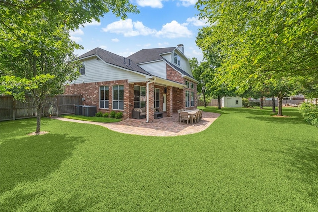 7327 Crescent Bridge Ct, Humble, TX 77396 - rear view of property featuring brick siding, a patio area, central air condition unit, and a chimney