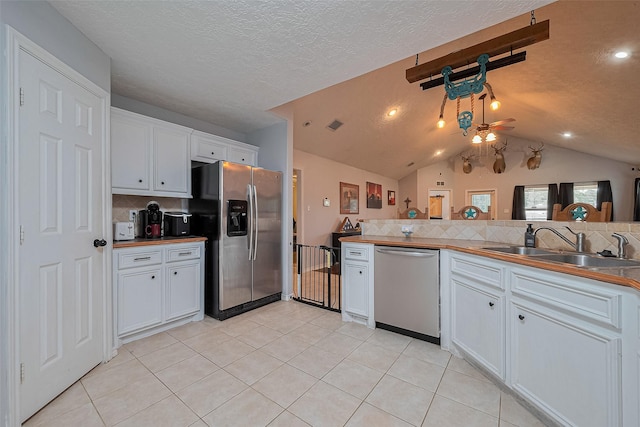 109 Moonspinner, Conroe, TX 77356 - kitchen with stainless steel appliances, a sink, backsplash, white cabinets, and ceiling fan