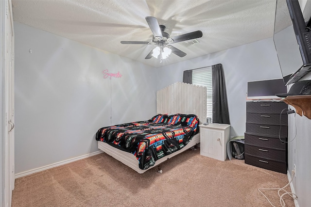109 Moonspinner, Conroe, TX 77356 - bedroom with light colored carpet, a ceiling fan, baseboards, and a textured ceiling