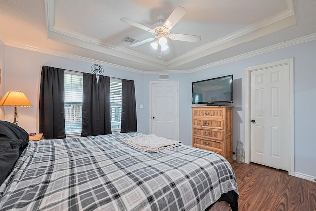 109 Moonspinner, Conroe, TX 77356 - bedroom featuring a raised ceiling, dark wood-type flooring, crown molding, and a ceiling fan