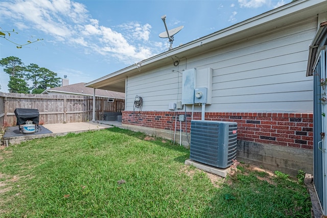 109 Moonspinner, Conroe, TX 77356 - view of home's exterior with central AC, a patio, and brick siding
