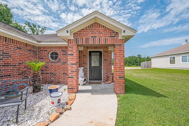 109 Moonspinner, Conroe, TX 77356 - view of exterior entry featuring brick siding and a yard