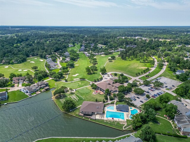 109 Moonspinner, Conroe, TX 77356 - aerial view of property's location featuring a local golf course, a pool area, and a nearby body of water
