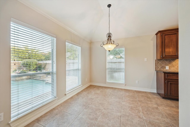 1044 Cayman Bend Ln, League City, TX 77573 - unfurnished dining area featuring light tile patterned floors, lofted ceiling, and baseboards