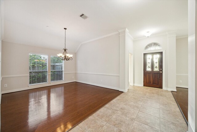 1044 Cayman Bend Ln, League City, TX 77573 - entrance foyer with a chandelier, crown molding, baseboards, wood finished floors, and vaulted ceiling