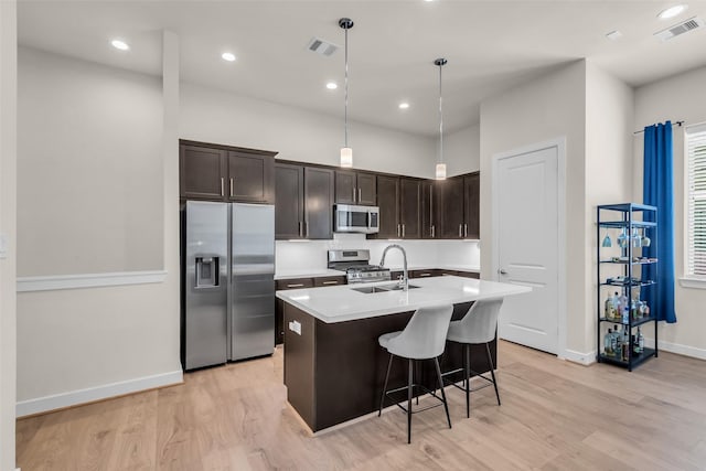 144 Knightsbridge Park Ln, Houston, TX 77018 - kitchen featuring appliances with stainless steel finishes, a sink, dark brown cabinetry, light countertops, and recessed lighting