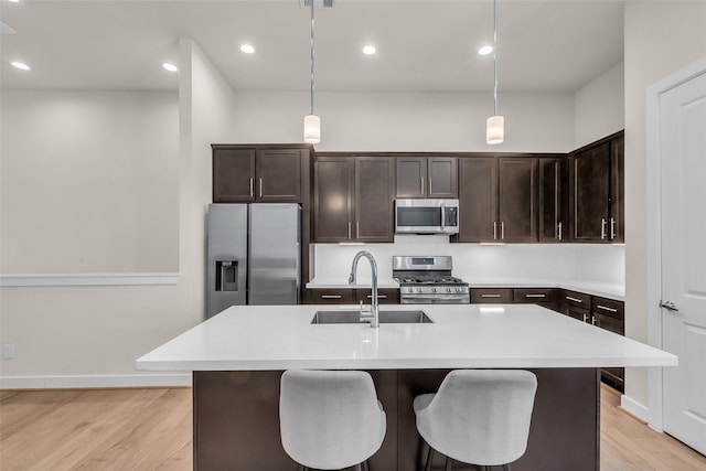 144 Knightsbridge Park Ln, Houston, TX 77018 - kitchen featuring stainless steel appliances, a sink, dark brown cabinetry, light countertops, and recessed lighting