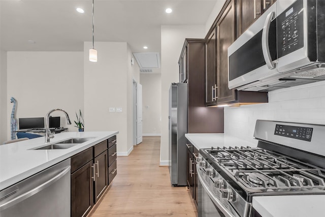 144 Knightsbridge Park Ln, Houston, TX 77018 - kitchen with stainless steel appliances, a sink, dark brown cabinets, light countertops, and recessed lighting