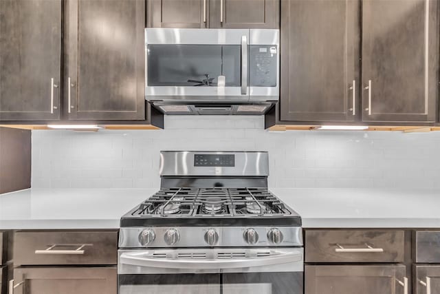 144 Knightsbridge Park Ln, Houston, TX 77018 - kitchen featuring appliances with stainless steel finishes, light countertops, dark brown cabinets, and decorative backsplash