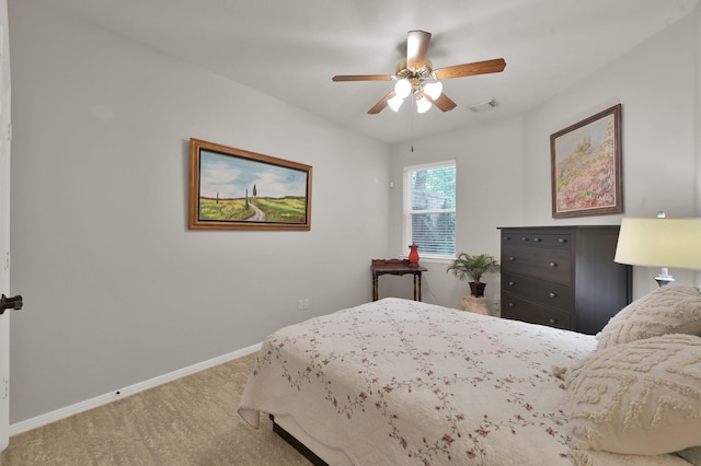 carpeted bedroom featuring baseboards and ceiling fan