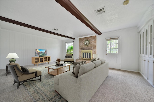 4822 Droddy St, Houston, TX 77091 - carpeted living room featuring healthy amount of natural light, beamed ceiling, a fireplace, a textured ceiling, and baseboards