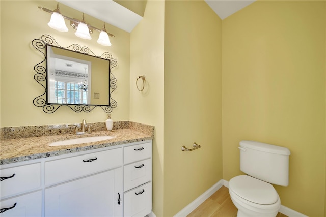 4822 Droddy St, Houston, TX 77091 - bathroom with baseboards, toilet, vanity, and wood finished floors