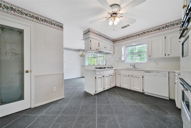 4822 Droddy St, Houston, TX 77091 - kitchen featuring dishwasher, a sink, a ceiling fan, white cabinets, and a peninsula
