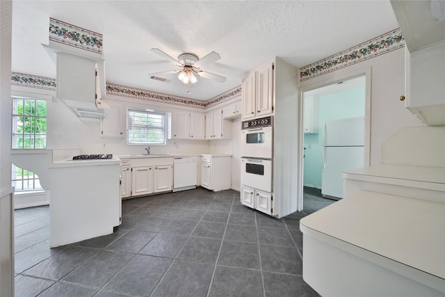 4822 Droddy St, Houston, TX 77091 - kitchen featuring white appliances, a ceiling fan, a sink, dark tile patterned flooring, and light countertops