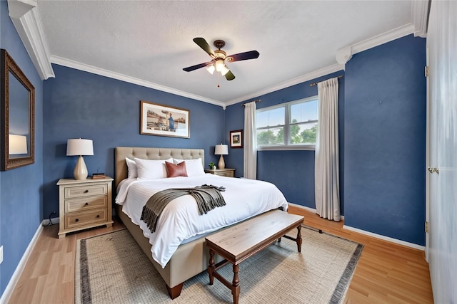 4822 Droddy St, Houston, TX 77091 - bedroom with light wood-style flooring, ornamental molding, baseboards, and a ceiling fan