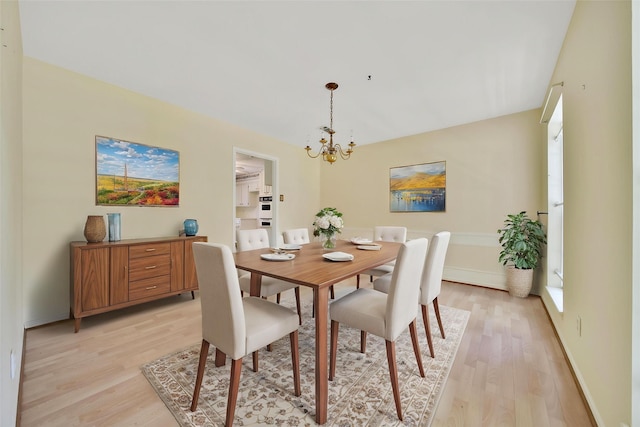 4822 Droddy St, Houston, TX 77091 - dining area featuring a chandelier, light wood-style flooring, and baseboards