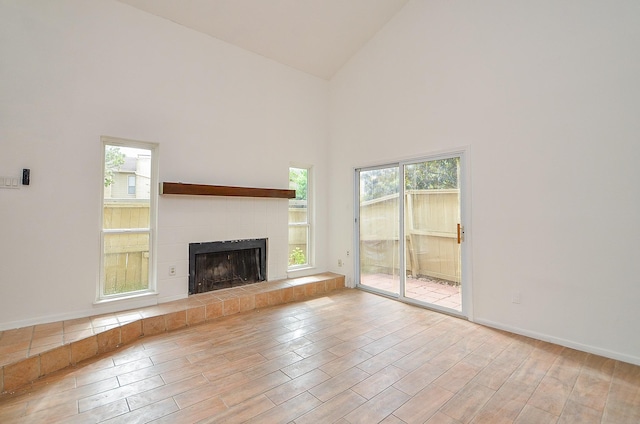 3538 Ocee St, Houston, TX 77063 - unfurnished living room with high vaulted ceiling, wood finished floors, healthy amount of natural light, and a fireplace
