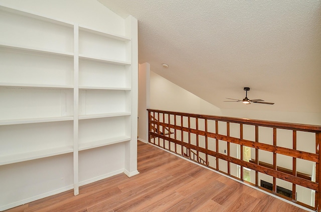 3538 Ocee St, Houston, TX 77063 - hall with wood finished floors, a textured ceiling, lofted ceiling, and baseboards