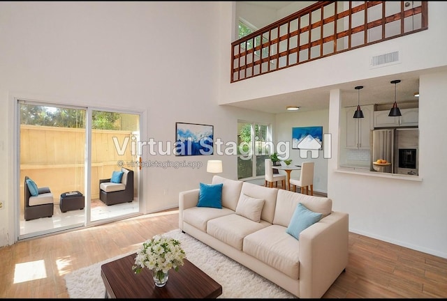 3538 Ocee St, Houston, TX 77063 - living area featuring wood finished floors, a high ceiling, and baseboards