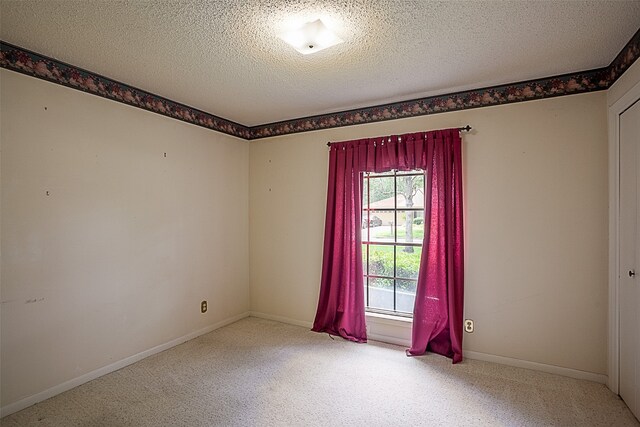 2812 Fairway Dr, Orange, TX 77630 - empty room with carpet, a textured ceiling, and baseboards