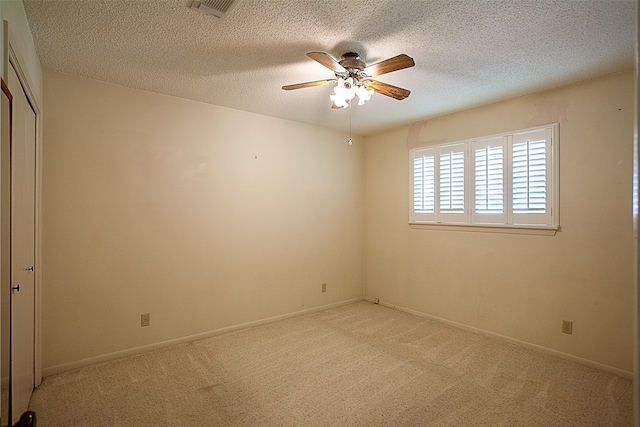 2812 Fairway Dr, Orange, TX 77630 - empty room with ceiling fan, light carpet, a textured ceiling, and baseboards