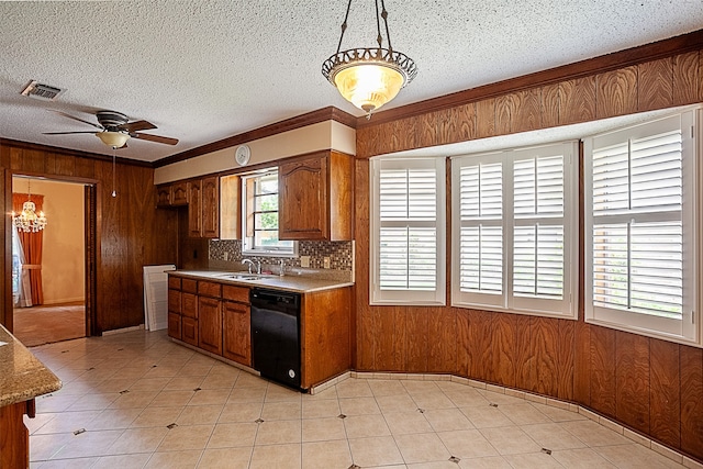 2812 Fairway Dr, Orange, TX 77630 - kitchen with dishwasher, a sink, wood walls, brown cabinets, and a ceiling fan