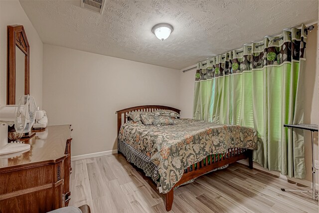 3619 Canton Hills Ln, Missouri City, TX 77459 - bedroom with a textured ceiling, wood finished floors, and baseboards