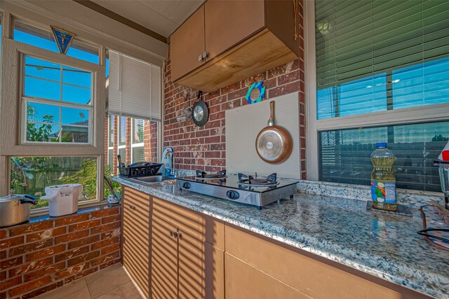 3619 Canton Hills Ln, Missouri City, TX 77459 - bar area featuring a sink, light tile patterned floors, and stovetop