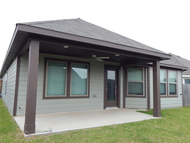228 Rustic Ridge Cir, Magnolia, TX 77354 - back of house with ceiling fan, a patio area, roof with shingles, and a yard