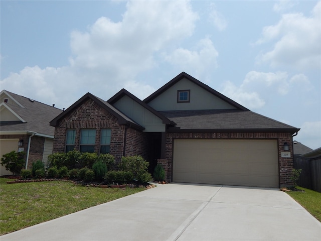 228 Rustic Ridge Cir, Magnolia, TX 77354 - view of front facade featuring brick siding, driveway, a garage, and a front lawn