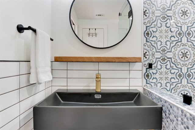 1127 Nadine St, Houston, TX 77009 - bathroom view of a sink, tile walls, and decorative backsplash