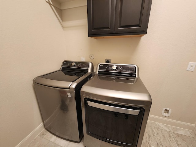 4723 Abercorn St, Rosharon, TX 77583 - washroom with cabinet space, washing machine and dryer, baseboards, and light marble finish floors